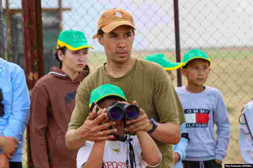 Albert Salemgareev (seen here helping schoolchildren view kulans on June 19) is a Kazakh conservation specialist who works on the Altyn Dala reserve. The ranger told RFE/RL that the corral in which the kulans live &ldquo;is arranged to create the most natural living conditions&rdquo; and includes a natural pond and depressions in the ground that he says are vital for kulans, who like to &ldquo;hide in secluded places, out of sight of our rangers.&quot; &nbsp;