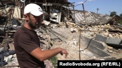 Andriy stands in the ruins of the post office building. “Before my eyes, they were simply shot and thrown into the basement,” he said.