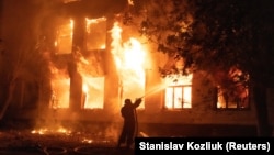 A firefighter attempts to put out a blaze at a hospital hit by a Russian missile strike in Mykolayiv on August 1.