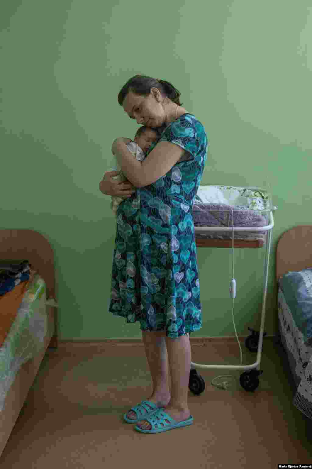 Olena, 36, holds her baby Mykhaylo.