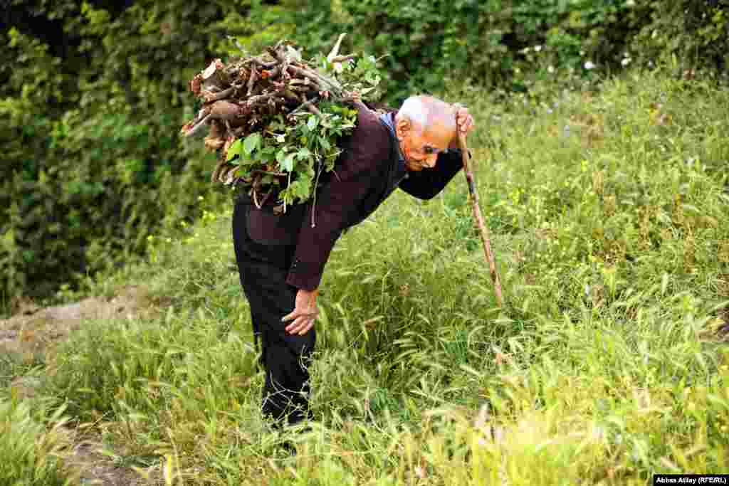 This man is collecting firewood. While most villages have electricity, some more remote settlements still rely on fires for heating and cooking. 