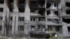 A Russian tank sits in front of a damaged apartment building in the town of Popasna in Ukraine's Luhansk region on May 26. 