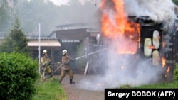 Firefighters put out a burning coffee kiosk -- a result of shelling in Kharkiv on May 26.