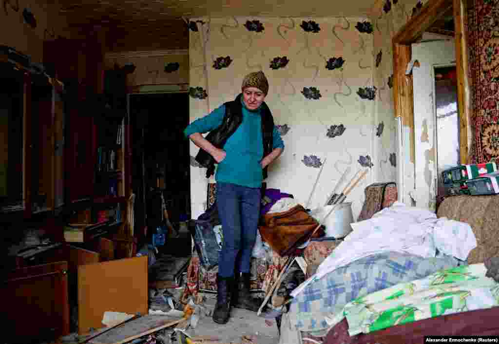 Natalia Kovalenko, 52, stands inside her damaged apartment in Popasna on May 26. Two days earlier, Ukrainian President Volodymyr Zelenskiy accused Russia of seeking to destroy everything in the town.