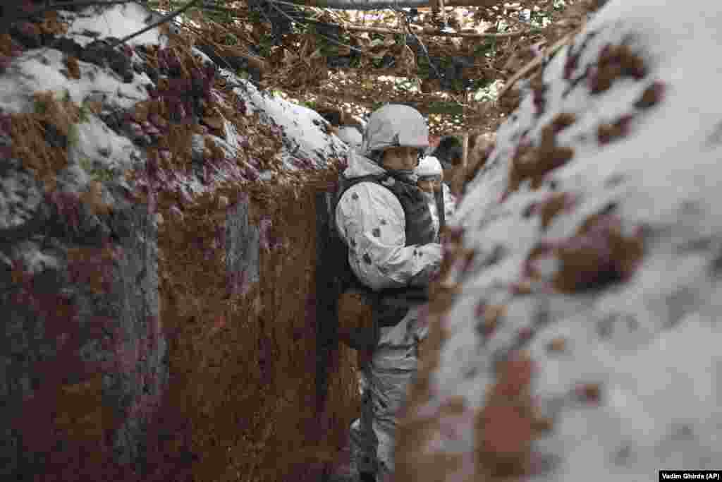 A Ukrainian serviceman stands in a trench at a frontline position with Moscow-backed separatists in the Donetsk region.