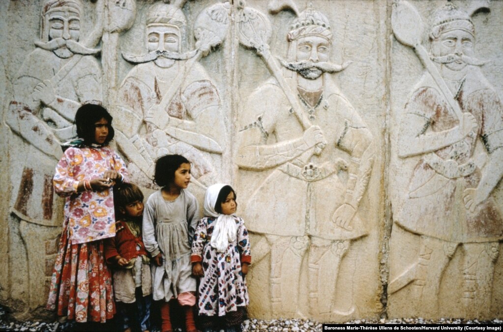 Children in front of a carving in Shiraz in southern Iran.