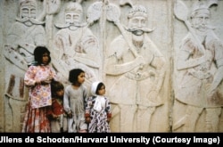 Children in front of a carving in Shiraz in southern Iran.