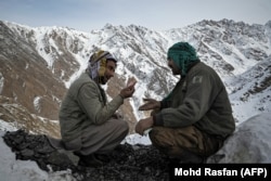 Men haggle over emeralds in the Mikeni Valley. The photos in this gallery were taken in mid-January 2022.