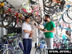 تصویر آرشیف: جاوید فیضی خبرنگارا رادیو آزادی در کابل در حال مصاحبه با مالک دکان بایسکیل فروشی