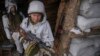 Ukrainian servicemen install a machine gun at an outpost on the front line in the Luhansk region in eastern Ukraine on January 29.