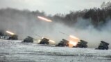 Multiple-rocket launchers fire on a snow-covered field during joint exercises of the armed forces of Russia and Belarus at a firing range in Belarus in February 2022.