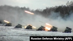 Multiple-rocket launchers fire on a snow-covered field during joint exercises of the armed forces of Russia and Belarus at a firing range in Belarus in February 2022.