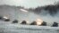 Multiple-rocket launchers fire on a snow-covered field during joint exercises of the armed forces of Russia and Belarus at a firing range in Belarus in February 2022.