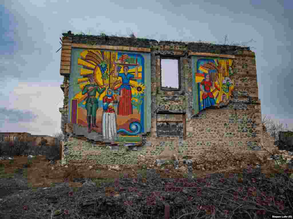 A Soviet-era mural still stands amid the city ruins. Lohr says he was told to move quickly to avoid Azerbaijani snipers that sometimes worked in the surrounding areas.