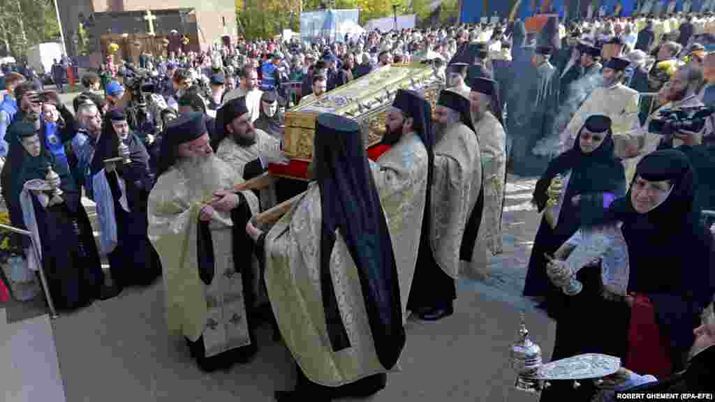 Two separate processions -- one with the relics of St. Demetrius; the other with the relics of St. Constantine and St. Helen as well as St. Nektarious of Aegnia -- met at the base of the hill of the Romanian Patriarchate before walking up together.