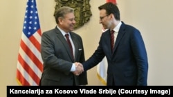 The U.S. special envoy for the Western Balkans,Gabriel Escobar, greets Petar Petkovic, director of the Office for Kosovo of the Government of Serbia, in Belgrade on October 20.