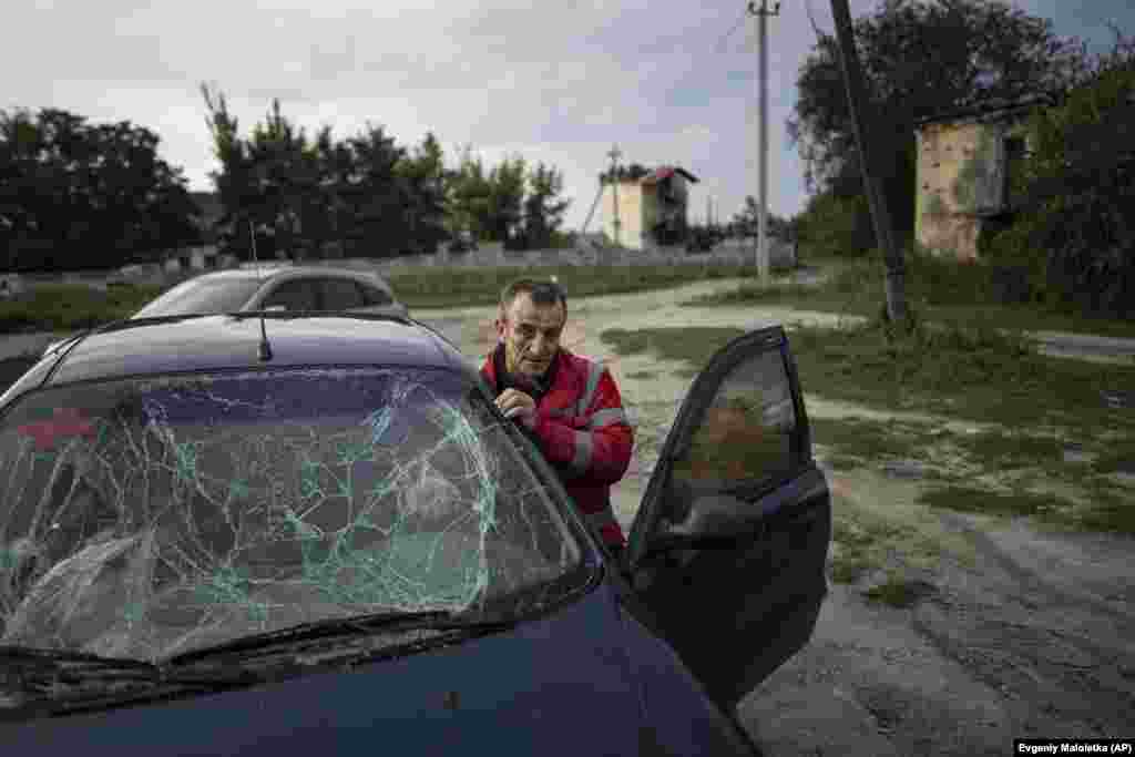 Kuznetsov prepares his car for the trip back to his house, which was badly damaged by Russian bombs. &nbsp;