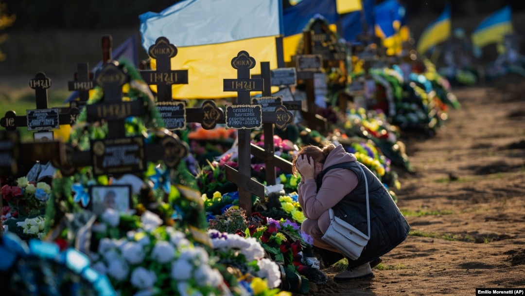 Tamara, 50, mourns at the grave of her only son, a Ukrainian soldier killed during a Russian bombing raid, at a cemetery in Mykolayiv on October 26.