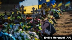 Tamara, 50, mourns at the grave of her only son, a Ukrainian soldier killed during a Russian bombing raid, at a cemetery in Mykolayiv on October 26.