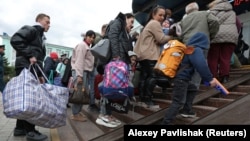 Civilians evacuated from the Russian-occupied Kherson region of Ukraine arrive at a railway station in the town of Dzhankoi, on the Russia-annexed Crimean Peninsula, on October 20.