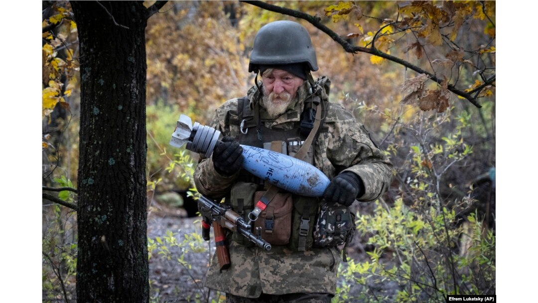 A Ukrainian soldier carries a shell with a written message to the Russian Army at a frontline position near Bakhmut on October 27.