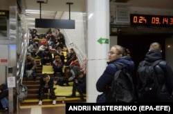 People shelter inside a Kyiv metro station amid a new wave of Russian strikes on October 31.