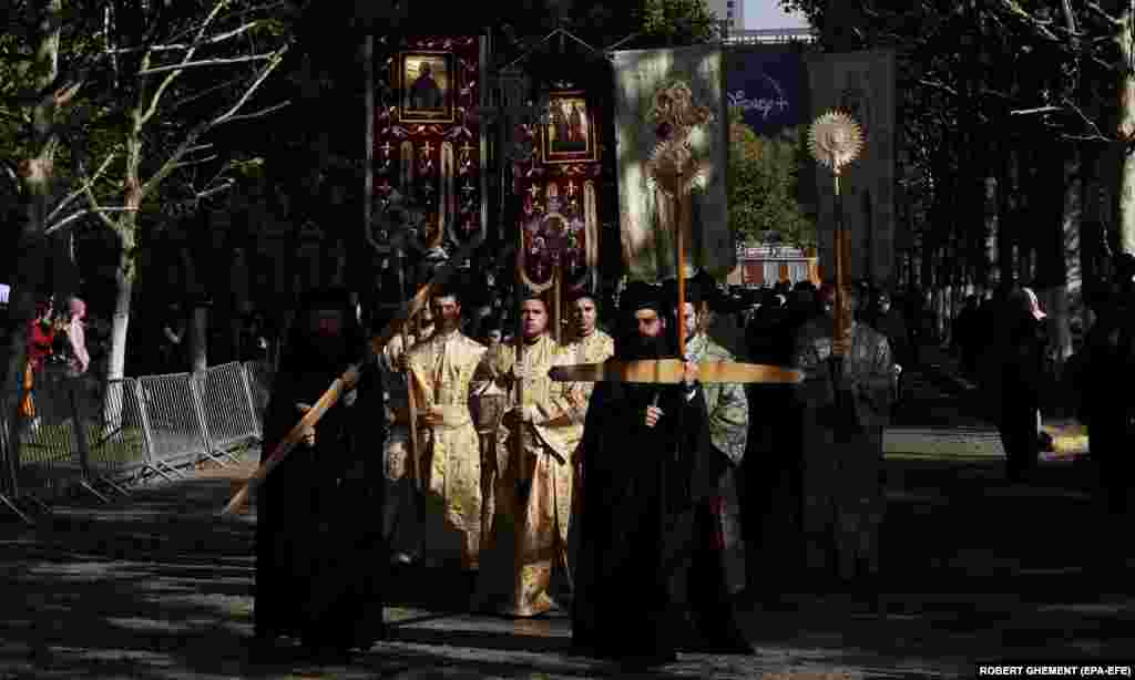Romanian Orthodox priests accompany the relics of St. Demetrius the New during a Way of the Saints religious procession in front of the Patriarchal Cathedral in Bucharest on October 24. Thousands of pilgrims from all over the country are expected to worship during the weeklong celebration, which began on October 22. &nbsp;