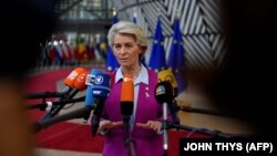 European Commission President Ursula von der Leyen addresses journalists after arriving for the first day of an EU leaders summit at the European Council in Brussels on October 20.