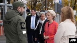 Estonian Prime Minister Kaja Kallas (right) and European Commission President Ursula von der Leyen (second right) visit Narva, Estonia's third-largest city, situated on the west bank of the Narva River by the Russian border, on October 10, 2022. 