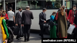 Aşgabatda jemgyýetçilik awtobusyna münýän we ondan düşýän ýolagçylar (Arhiw suratlary)