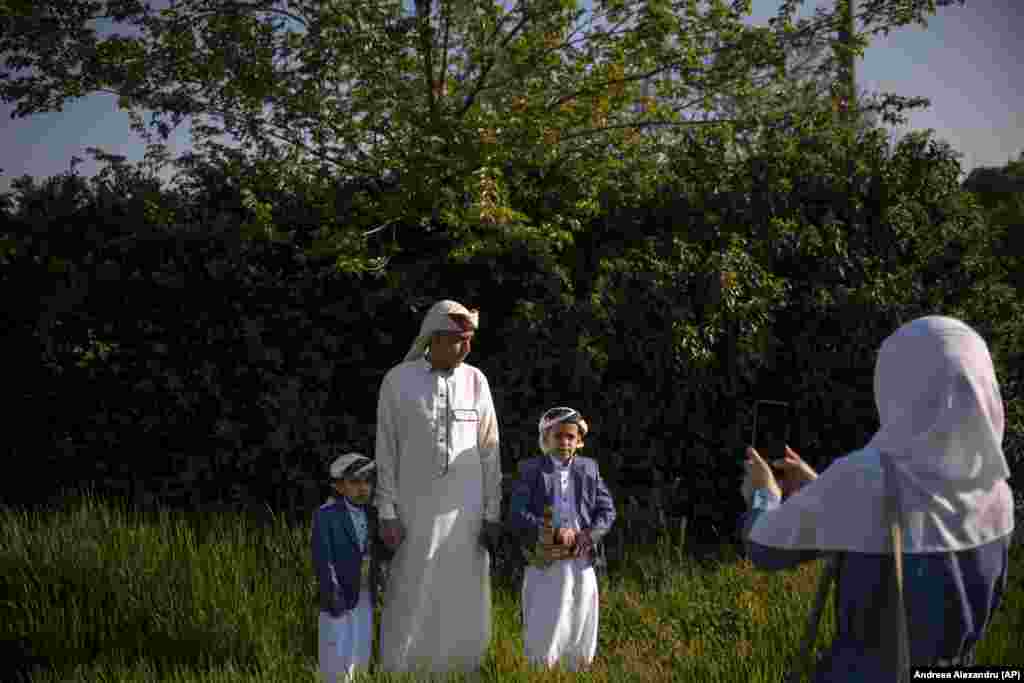 People take pictures after attending Eid al-Fitr prayers in Bucharest on May 2.