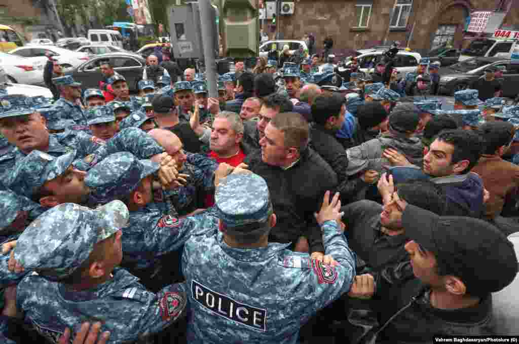 Police surround protesters in Yerevan on May 3. On April 13, Pashinian told parliament: &quot;I am guilty that in 2018-19 I did not stand before our society and relay that all of our -- I repeat, all of our -- friends near and far expect us to hand over seven famous [disputed regions in and around Nagorno-Karabakh] to Azerbaijan in one way or another...&quot;