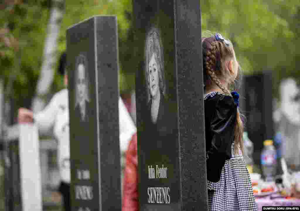 Visitors pay their respects to loved ones at the St. Lazarus Cemetery in Chisinau, Moldova.