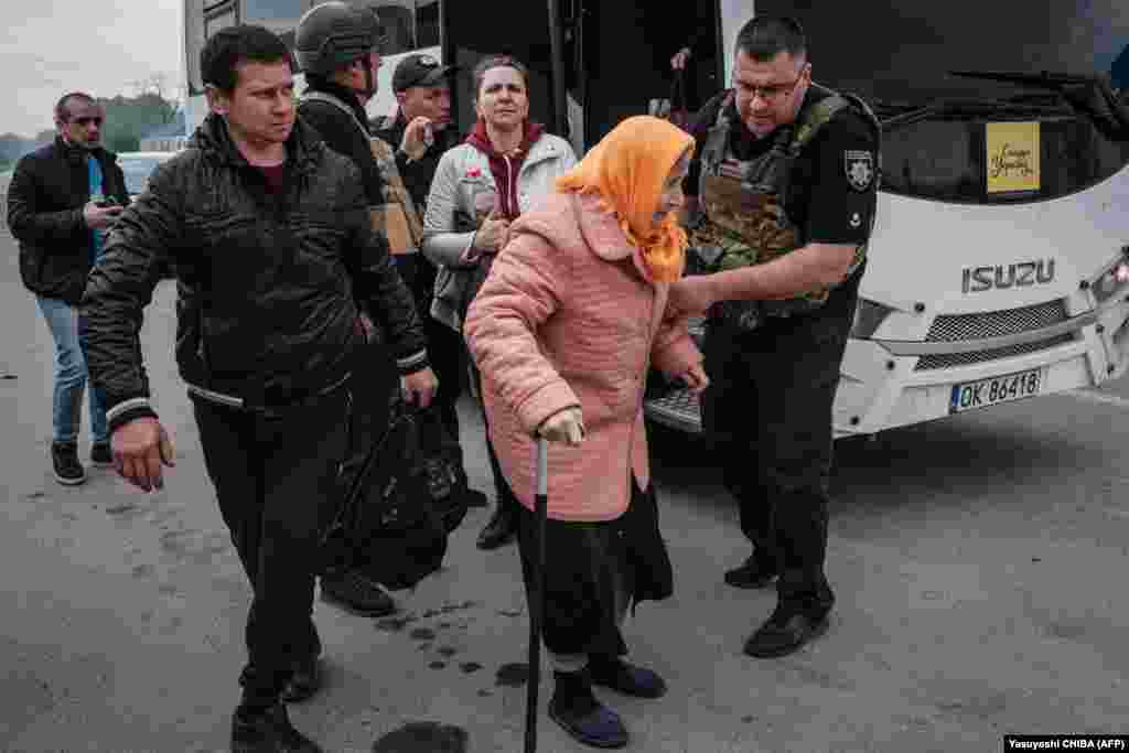 Egy idős nőnek segítenek leszállni a buszról, amely a Limanból menekülőket szállította&nbsp;Rajhorodokba május 2-án