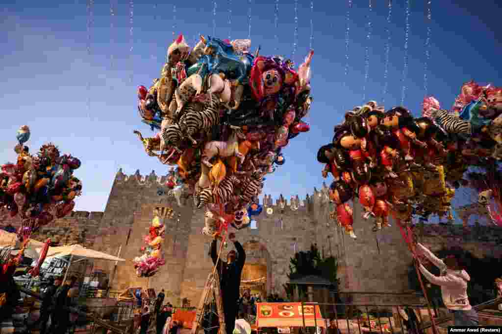Vendors set up balloons for sale in front of the Damascus Gate in Jerusalem&#39;s Old City to mark the end of the holy month of Ramadan on May 2.