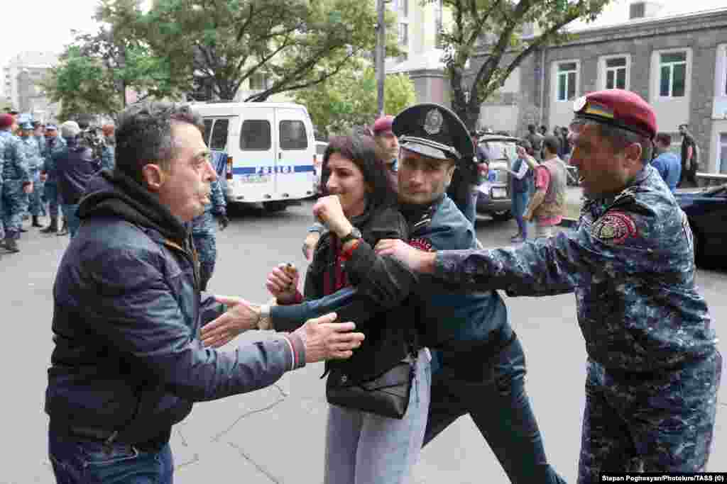 A woman is detained by police in Yerevan on May 3.&nbsp; The prime minister&#39;s political allies accuse the opposition of exploiting the Karabakh issue in a bid to seize power. They point to recent elections that reinstated the ruling party after the large-scale conflict with Azerbaijan in 2020.&nbsp;