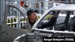 A worker at the PCMA Rus car-assembly plant in Russia's Kaluga region in 2019 in what was initially a joint project by PSA Peugeot Citroen and Mitsubishi Motors Corporation.