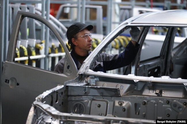 A man works on a car assembly line at the PCMA Rus car plant in Rosva Industrial Park in the Kaluga region.