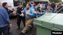 Police detain opposition protesters in Yerevan on May 2.