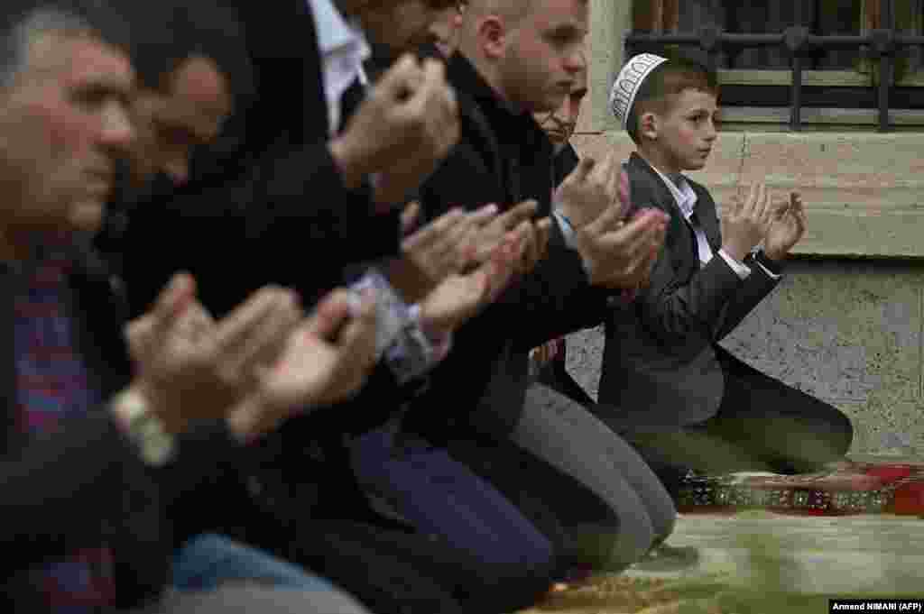 A young Kosovar Muslim devotee offers prayers at the Grand Mosque in Pristina on May 2. &nbsp;