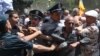 Police clash with protesters after they tried to enter a government building in Yerevan on May 30.