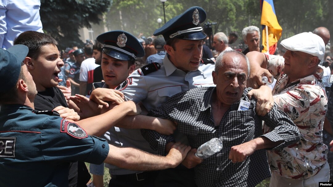 Police clash with protesters after they tried to enter a government building in Yerevan on May 30.