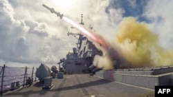A US guided missile destroyer of the type shown above fired on an Iranian-flagged cargo ship seeking to evade a blockade (file photo).