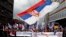 Protesters wave a large Serbian flag during a demonstration against NATO in Belgrade in March 2016. 