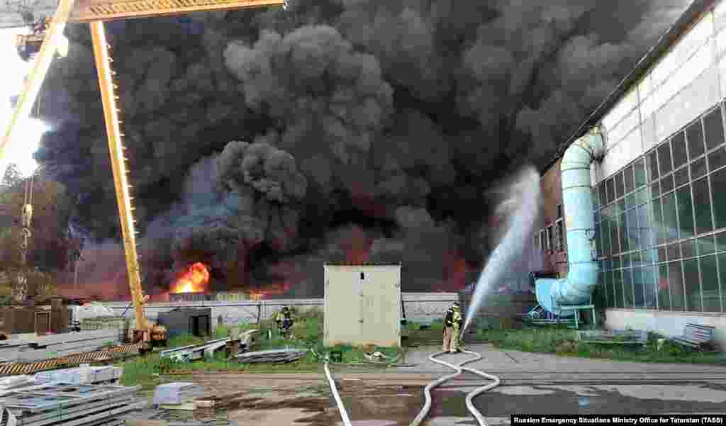 Firefighters face a wall of smoke at the Altyn Polimer production facility in the Tatarstan region on June 3. Rubber and plastics were reportedly stored at the factory.&nbsp;