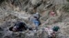 Ukraine -- Four bodies lie in a mass grave, including the village mayor Olha Sukhenko and her family, in Motyzhyn close to Kyiv, Ukraine, Monday, April 4, 2022