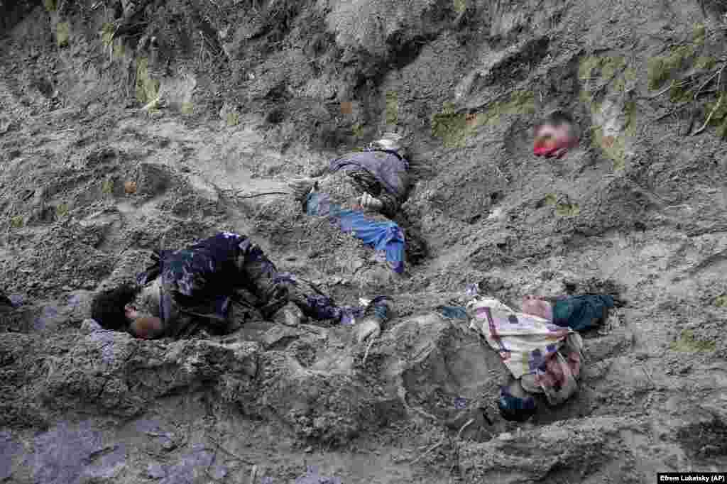 The&nbsp;bodies of the mayor of Motyzhyn and her family lie in a mass grave on April 4 after being uncovered following the withdrawal of Russian forces from an encirclement of Kyiv. Members of the family had their hands bound before being executed.