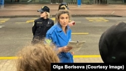 Olga Borisova, a member of Pussy Riot, posted this photo on May 31 of Aisoltan Niyazova (center) being arrested as the group entered Croatia from neighboring Slovenia.