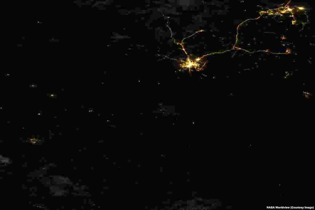 The northeastern Ukrainian city of Kharkiv (center of this image) is difficult to spot in a nighttime satellite image made on July 5, 2026. Just to the northeast, Russia's Belgorod and its well-lit highways appear largely unchanged from the historic photo, made in August 17, 2021.