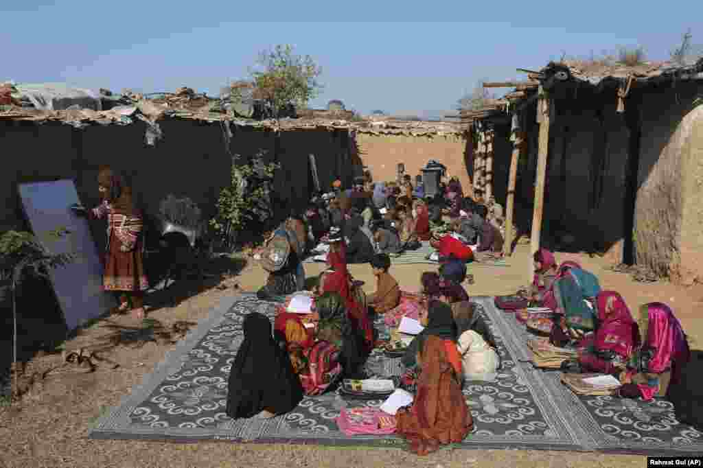 Afghan refugee schoolchildren attend a class at a makeshift school on the outskirts of Islamabad, Pakistan.